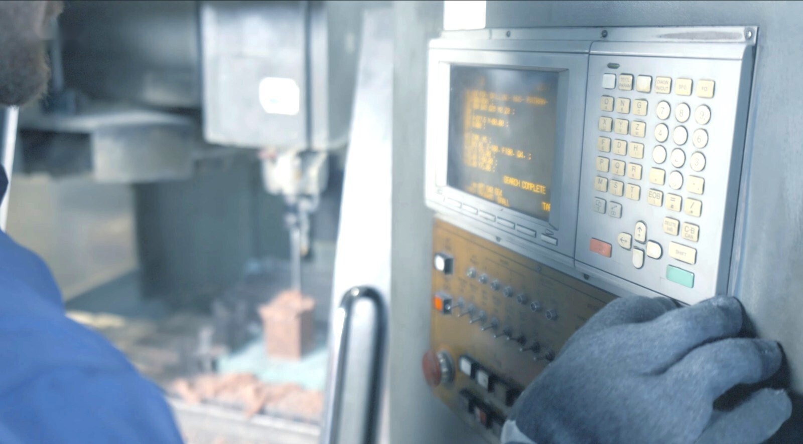 Operator at a multi-axis CNC machining centre in the Rastgar machine shop